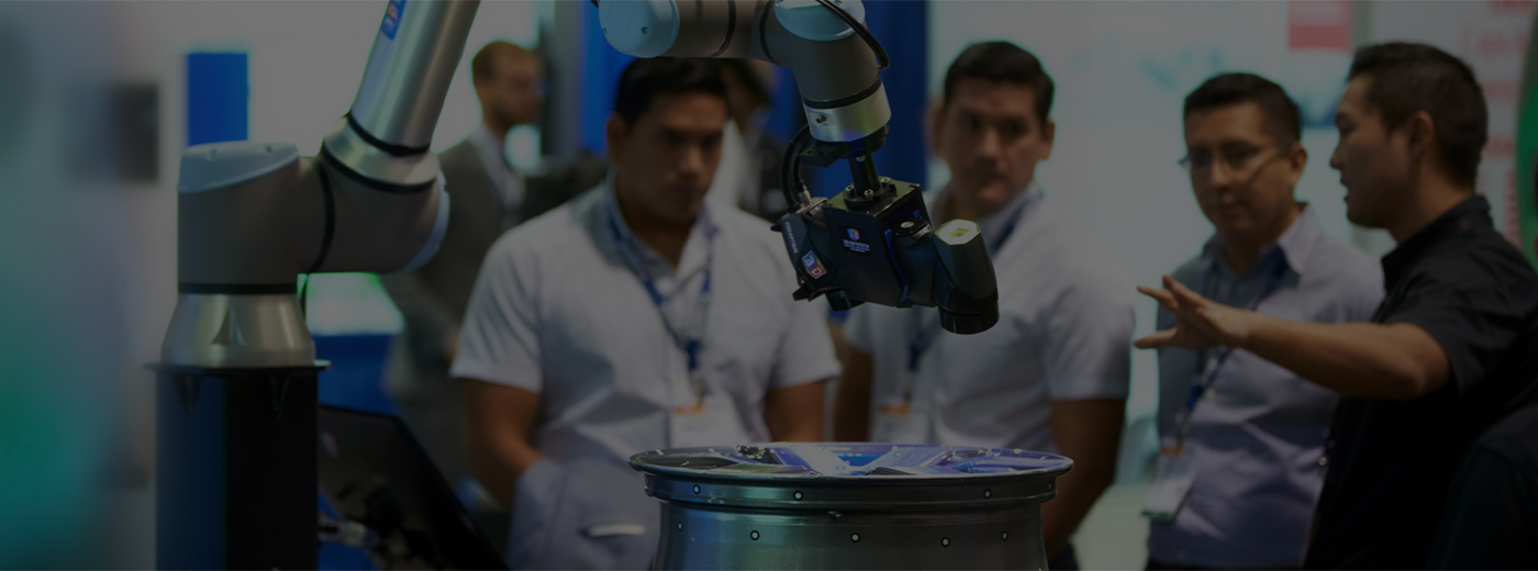 Men view robotic arm