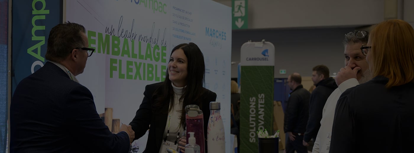 An expo attendee smiling and talking to a registration customer service representative 